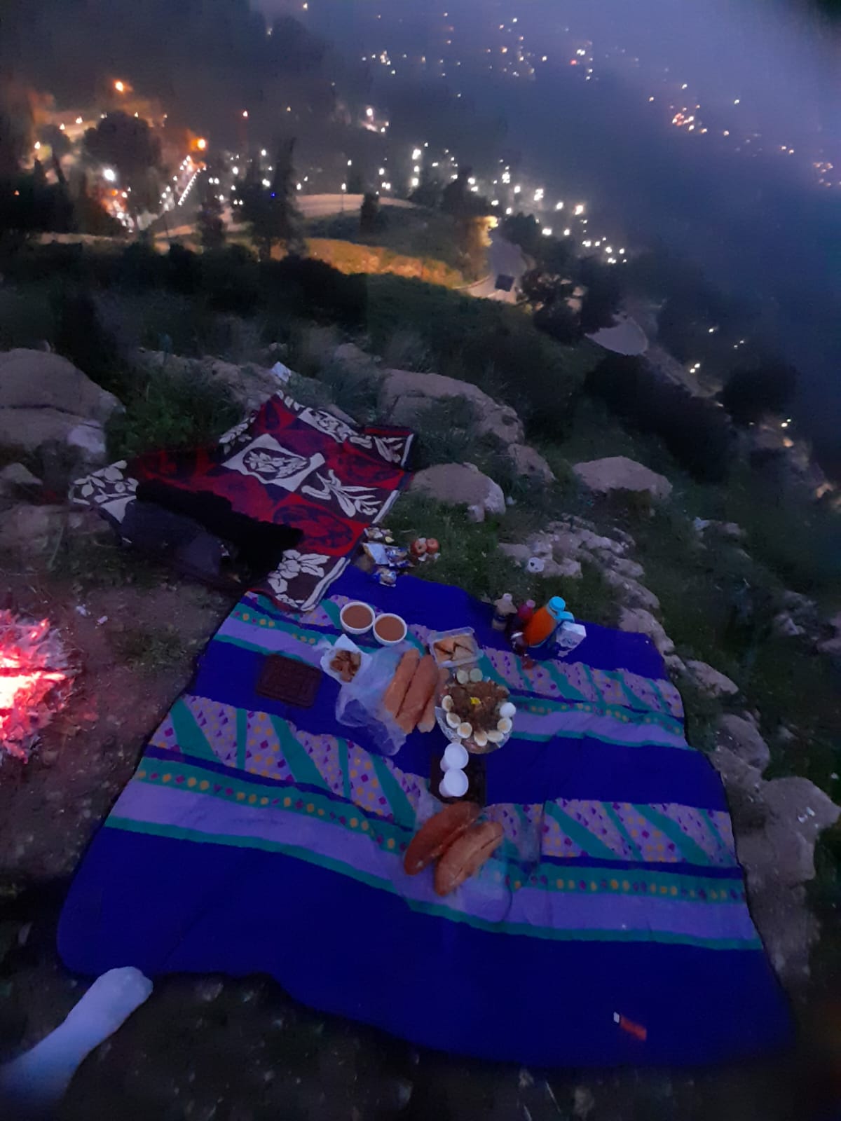 An iftar table in Morocco at sunset: dates, harira soup, milk, msemen, and chebakia laid out for breaking the fast.