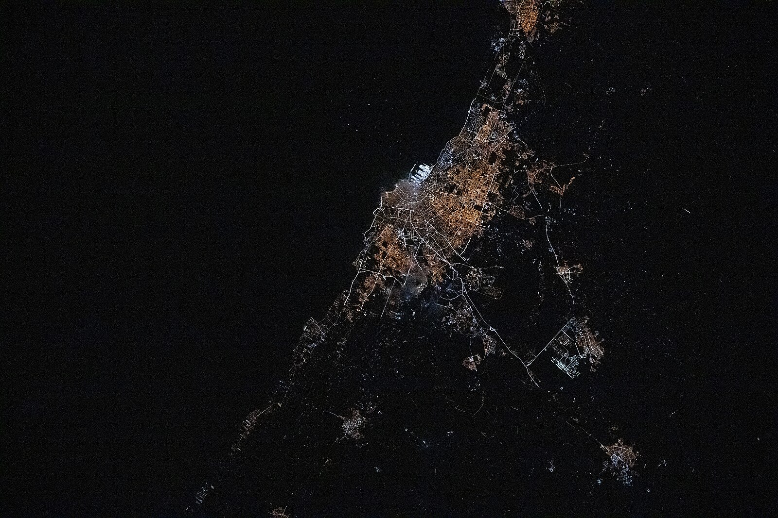 A photograph of Casablanca at night taken from the International Space Station, showing the city lights and Atlantic coast.